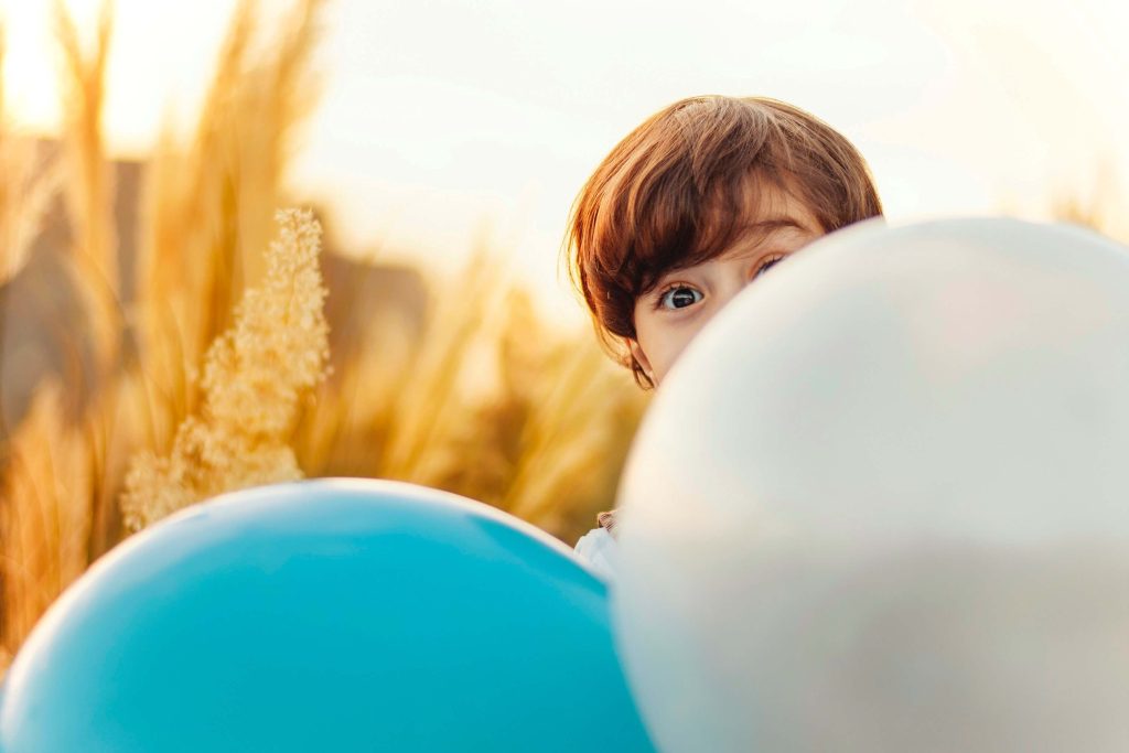 Kid playing with balloons